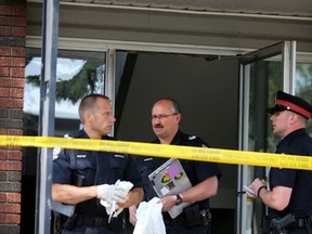 Forensic team bring out some evidence. Police investigates a suspicious death in a apartment on 104 ave and 106 st in Edmonton, Alberta on Tuesday August 25, 2015. Perry Mah/Edmonton Sun