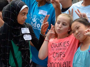 Zainab Ahmed, 12, Olivia Dinel, 11, and Rachel Derbyshire, 11,  representing the Muslim, Christian, and Jewish faiths reprectively, l-r, have fun at the third annual London Interfaith Peace Camp held at King's University College. About 60 campers will visit places of worship and learn about fellow campers and their beliefs through recreational activities. The camp ends on Friday. (MORRIS LAMONT, The London Free Press)