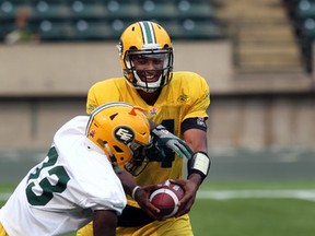 Eskimos quarterback James Franklin hands off to running back Shakir Bell during practice at Commonwealth Stadium on Wednesday. (Perry Mah, Edmonton Sun)