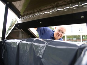 Brad Parkes, executive director of the Department of Facility Services at Laurentian University shows off the bear proof trash cans in Sudbury, Ont. on Wednesday, August 26, 2015. Gino Donato/Sudbury Star/Postmedia Network