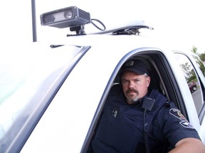 Const. Rick Carr of the Greater Sudbury Police Service traffic management unit was out using the service's new automated licence plate recognition system in Sudbury, Ont. on Wednesday, August 26, 2015. Gino Donato/Sudbury Star/Postmedia Network