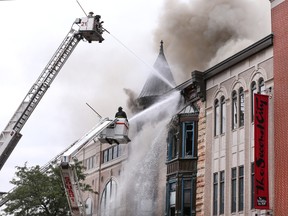 Chicago firefighters battle a fire in a building that houses the offices of Chicago's famed Second City theater company in Chicago on Wednesday, Aug. 26, 2015. Second City announced that shows and classes for the day have been canceled although the fire did not reach the theater. (Chris Sweda/Chicago Tribune via AP)