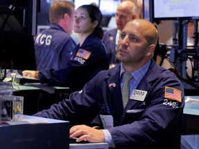 Specialists John Parisi, right, and Amanda Anderson work on the floor of the New York Stock Exchange Thursday, Aug. 27, 2015. (AP Photo/Richard Drew)