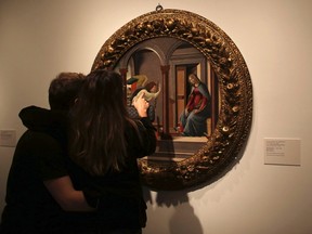 A couple look at the "Annunciation", a painting by artist Sandro Botticelli, during the "Masters of the Renaissance, Masterpieces from Italy" exhibition at the Bank of Brazil Cultural Centre in Sao Paulo July 13, 2013. REUTERS/Nacho Doce