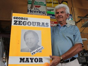 SAMANTHA REED/FOR THE INTELLIGENCER
Roger Ling, owner of PM Industries, holds a 1985 campaign sign of the late George Zegouras during his re-election bid for mayor of Belleville. Ling says the upcoming federal election is not keeping him as busy as municipal elections normally do.