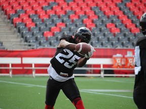 Defensive back Brandyn Thompson reaches out to make a grab during Ottawa RedBlacks practice Thursday at TD Place. TIM BAINES/OTTAWA SUN