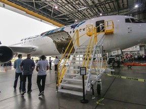 People tour the new WestJet Boeing 767-300 extended range aircraft at the WestJet hangar in Calgary, Ab., on Thursday August 27, 2015. The aircraft is too big to fit in the existing WestJet bays. Mike Drew/Calgary Sun/Postmedia Network
