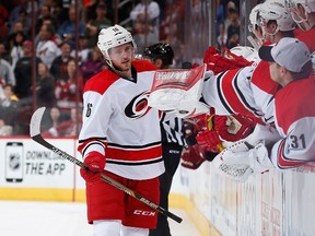 Elias Lindholm of the Carolina Hurricanes high fives teammates on the bench after scoring a shootout goal against the Arizona Coyotes at Gila River Arena on February 5, 2015 in Glendale, Ariz. (Christian Petersen/Getty Images/AFP)