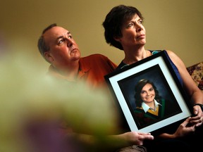 Gordon Stringer, left, and his wife, Kathleen Stringer, pose with a framed portrait of their daughter, Rowan.  (Postmedia Network Files)