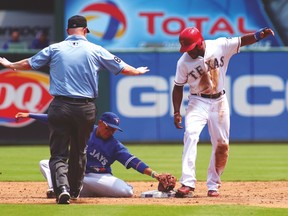Jays second baseman Ryan Goins applies the tag on Rangers’ Delino DeShields, who was called safe on the steal attempt but ruled out after a review. (USA TODAY SPORTS)