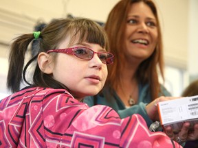 Camille Gaudette with her mother, Natalie Genereux, smiles at Chartrand's Independent Grocer  in Chelmsford, Ont. on Thursday, August 27, 2015. Camille received a trip to Disney courtesy of the Make-A-Wish Foundation of Eastern Ontario. Gino Donato/The Sudbury Star/Postmedia Network