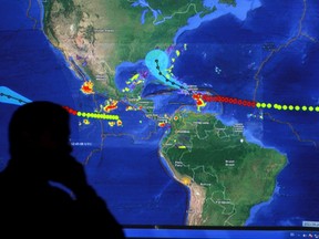 A member of the Emergency Operations Committee (COE) monitor the trayectory of Tropical Storm Erika via satellite in Santo Domingo, August 28, 2015. (REUTERS/Ricardo Rojas)