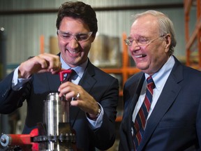 Liberal leader Justin Trudeau and former prime minister Paul Martin work with a plasma torch in Montreal on Aug. 28, 2015. (THE CANADIAN PRESS/Paul Chiasson)