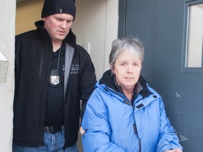 In this file photo, Port Hope Police escort school teacher Leslie Barton to a police cruiser for her first court appearance facing charges of sexual exploitation and sexual assault involving a former student at the school in Port Hope, Ont. on Feb. 12, 2015. Barton turned herself in to police. Pete Fisher/Northumberland Today/Postmedia Network/File