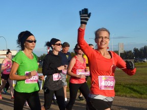 A runner gives the camera a wave during the 2014 Rotary Run for Life. - File Photo