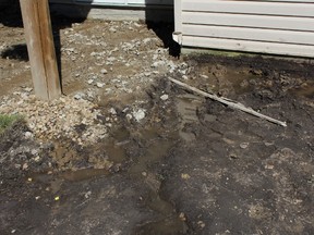 Doug Murdy, a home owner in Stony Plain, says two dump trucks were required to remove the mud from his backyard after the ground was excavated, resulting in three feet of pooling water, last summer. Files dated seven years after the home was built show it was non-compliant with six sections of the Alberta Building Code that was to be observed in 1997. - Photo Supplied