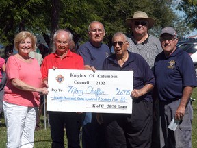 Marg Sheffer of Wallaceburg was this year's winner of the Knights of Columbus WAMBO 50/50 draw. She won $20,775. Presenting her with her cheque are Knights of Columbus members Jack Renders, Fred Dubuque, Don Rose, John VanSegbrook and Barry McFadden.