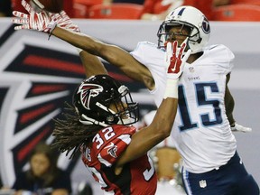 Titans wide receiver Justin Hunter (15) tries to make the catch against Falcons cornerback Jalen Collins (32) during NFL preseason action in Atlanta on Friday, Aug. 14, 2015. (David Goldman/AP Photo)