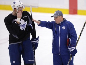 Interim coach Steve Spott (right) talks with Cody Franson. during the Toronto Maple Leafs’ practice at the Mastercard Centre Tuesday January 6, 2015. (Craig Robertson/Toronto Sun/Postmedia Network)