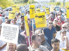 Taxi drivers demonstrate earlier this month after comments made by Quebec Premier Phillipe Couillard saying that he?d allow ride-sharing service Uber to operate legally in the province, in Montreal. (Graham Hughes, The Canadian Press)