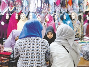 Women shop in an array of colourful headscarves, or hijab, at a market in Jakarta, Indonesia. (Nyimas Laula, Reuters)