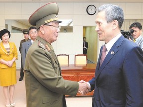 In this photo provided by the South Korean Unification Ministry, South Korean presidential security adviser Kim Kwan-jin, right, shakes hands with Hwang Pyong So, North Korea?s top political officer for the Korean People?s Army, after their meeting at the border village of Panmunjom earlier this week. (The South Korean Unification Ministry/ Associated Press)