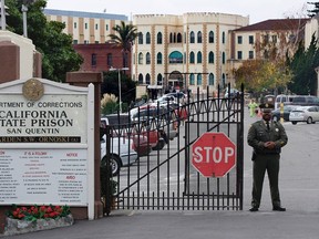 A guard stands at the gate of the San Quentin prison in San Quentin, California, in this file photo taken December 12, 2005. An inmate at San Quentin State Prison on San Francisco Bay was diagnosed with Legionnaires' disease and about 20 others showed symptoms of pneumonia, prompting officials to shut off water service at the institution, a prison spokeswoman said on Friday. REUTERS/Kimberly White /Files