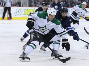 Dallas Stars centre Cody Eakin (left) fends off Winnipeg Jets centre Mathieu Perrault during NHL action at MTS Centre in Winnipeg Sat., Jan. 31, 2015. (Kevin King/Winnipeg Sun/Postmedia Network)