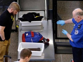 A TSA agent instructing a traveler. 

AP Photo/Elaine Thompson