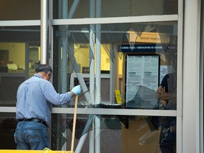 A front window to the left side of the entrance remains under repair after a man smash it with a traffic barrier Friday evening.  (DANI-ELLE DUBE/OTTAWA SUN/POSTMEDIA NETWORK)