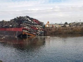 A Seaspan barge carrying old cars is shown in Victoria on Friday Aug. 28, 2015. British Columbia's Ministry of Environment says a barge has tipped in Victoria's harbour, dumping as many as 20 vehicles into the water. THE CANADIAN PRESS/HO-Ministry of Environment