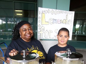Malachi Slack and his grandmother Marlene work the lemonade stand at the entrance to Health Sciences North in Sudbury, Ont. on Friday, August 28, 2015. Gino Donato/Sudbury Star/Postmedia Network