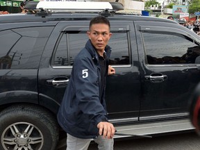 Policemen escort a car - part of a convoy carrying a suspect in the August 17 Bangkok shrine bombing - leaving a compound after police said they detained a foreign man in a Bangkok suburb on August 29, 2015.  Thai authorities on August 29 detained and charged a 28-year-old Turkish man over a bomb attack in Bangkok last week that killed 20 people and wounded scores more. It is the first arrest in connection with the 17 August bombing at the Erawan shrine in the capital's bustling downtown district, which killed mostly Asian visitors, in Thailand's worst single mass-casualty attack. (AFP PHOTO / Christophe ARCHAMBAULT)