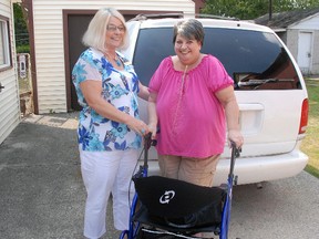 Caressant Care on Bonnie Place director of nursing Diane Hollingsworth, left, greets Betty Demkey and her brand new walker at her St. Thomas home. Caressant Care purchased the device for Demkey after her old walker was stolen last week.