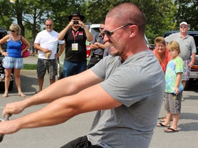 Rob Hunter of Fergus competes in the Strong Man Competition's bus pull at the County of Frontenac's 150th Anniversary in Harrowsmith, Ont. on Saturday August 29, 2015. Steph Crosier/Kingston Whig-Standard/Postmedia Network