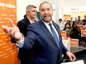 NDP Leader Tom Mulcair speaks to supporters along with candidate Andrew Thomson, left, during a campaign stop in Toronto on Thursday, August 27, 2015. THE CANADIAN PRESS/Frank Gunn