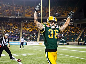 After having a couple of calls go against him, Eskimos defender Aaron Grymes celebrates his interception (Codie McLachlan, Edmonton Sun).