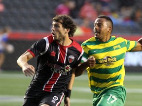 Ottawa Fury FC forward Tommy Heinemann fights for position with Tampa Bay Rowdies defender Tamika Mkandawire as the teams met at TD Place on Saturday, Aug. 29, 2015. (Chris Hofley/Ottawa Sun)