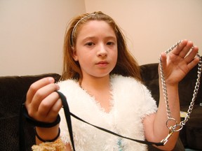 Jessika Dudley, 9, holds up a leash for the family dog, Cap. The three-month old puppy died hours after the Dudley family picked it up from a Dunvegan, Ont. farm.
MATT DAY/OTTAWA SUN