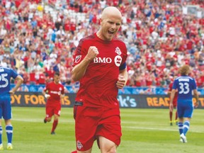 Toronto FC’s Michael Bradley celebrates after opening the scoring in the first half of yesterday’s game against the Montreal Impact at BMO Field. The Reds held on for a 2-1 victory, moving nine points clear of the playoff line in their bid to make the MLS post-season for the first time. (Chris Young, The Canadian Press)