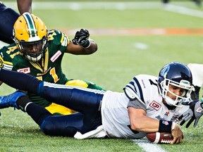 Eskimos’ Odell Willis tackles Argos quarterback Trevor Harris on Friday night in Edmonton, where Toronto lost 38-15. (CODIE MCLAUGHLIN/POSTMEDIA NETWORK)