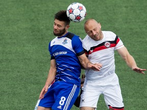 FC Edmonton's Ritchie Jones and Atlanta's Simon Mensing battle in an NASL game July 2015. (David Bloom)