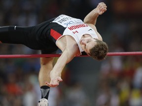 Canada's Derek Drouin competes in the final of the men's high jump athletics event at the 2015 IAAF World Championships at the "Bird's Nest" National Stadium in Beijing on August 30, 2015.  (AFP PHOTO / ADRIAN DENNIS)