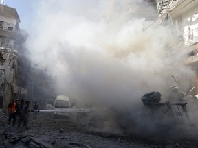 Civil defense members try to put out a fire at a site hit by what activists said were airstrikes by forces loyal to Syria's President Bashar al-Assad in the Douma neighborhood of Damascus, Syria August 24, 2015. (REUTERS/Bassam Khabieh)