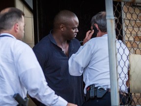 Shannon J. Miles, 30, is walked out of the Harris County Sheriff's Department in Houston on Saturday, Aug. 29, 2015. Prosecutors on Saturday charged Miles with capital murder in the killing of a uniformed sheriff's deputy who was gunned down from behind while filling his patrol car with gas. (Marie D. De Jesus/Houston Chronicle via AP)