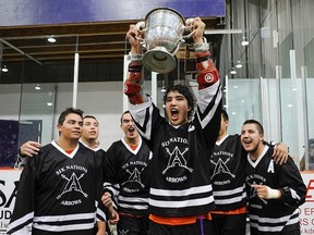 Wallaceburg's Jordan Durston, far right, celebrates with captain Brendan Bomberry, centre, and other Six Nations Arrows after winning the Minto Cup as Canadian junior 'A' lacrosse champions Saturday at the Iroquois Lacrosse Arena. (WARD LAFORME JR./Postmedia Network)