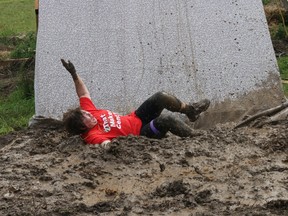 BRUCE BELL/THE INTELLIGENCER
Tina Furmidge of Scotiabank Trenton hits the mud at the bottom of the 14-foot slide during the second annual Grapes of Wrath Extreme Romp N’ Stomp at Hillier Creek Estates Winery on Saturday.