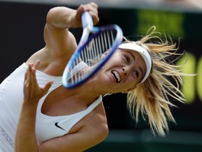 In this July 1, 2015, file photo, Maria Sharapova, of Russia, serves to Richel Hogenkamp, of the Netherlands, during their singles match at the All England Lawn Tennis Championships in Wimbledon, London.  (AP Photo/Pavel Golovkin, File)