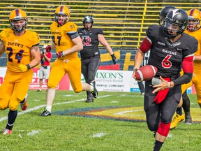Jesse Mills makes a run for Ottawa’s Ravens but it is not enough to tie up the OUA football season opener against Queen’s University Golden Gaels. Queen’s Gaels won 34-24 at Richardson Stadium in Kingston on Sunday, August 30th 2015. Kendra Pierroz, Whig-Standard / Postmedia Network