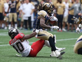 Winnipeg Blue Bombers KR Troy Stoudermire is brought down by Calgary Stampeders DB Dexter Janke during CFL action at Investors Group Field in Winnipeg on Sat., Aug. 29, 2015.